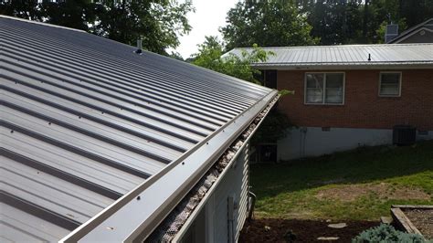 installing gutters on a house with metal roof|metal roof overhang into gutter.